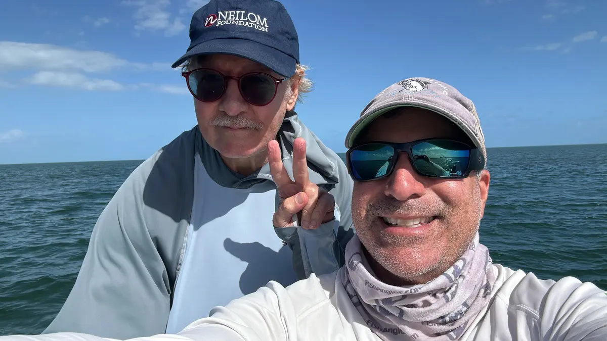 Captain Mo with a happy client on a Biscayne Bay fishing charter Miami