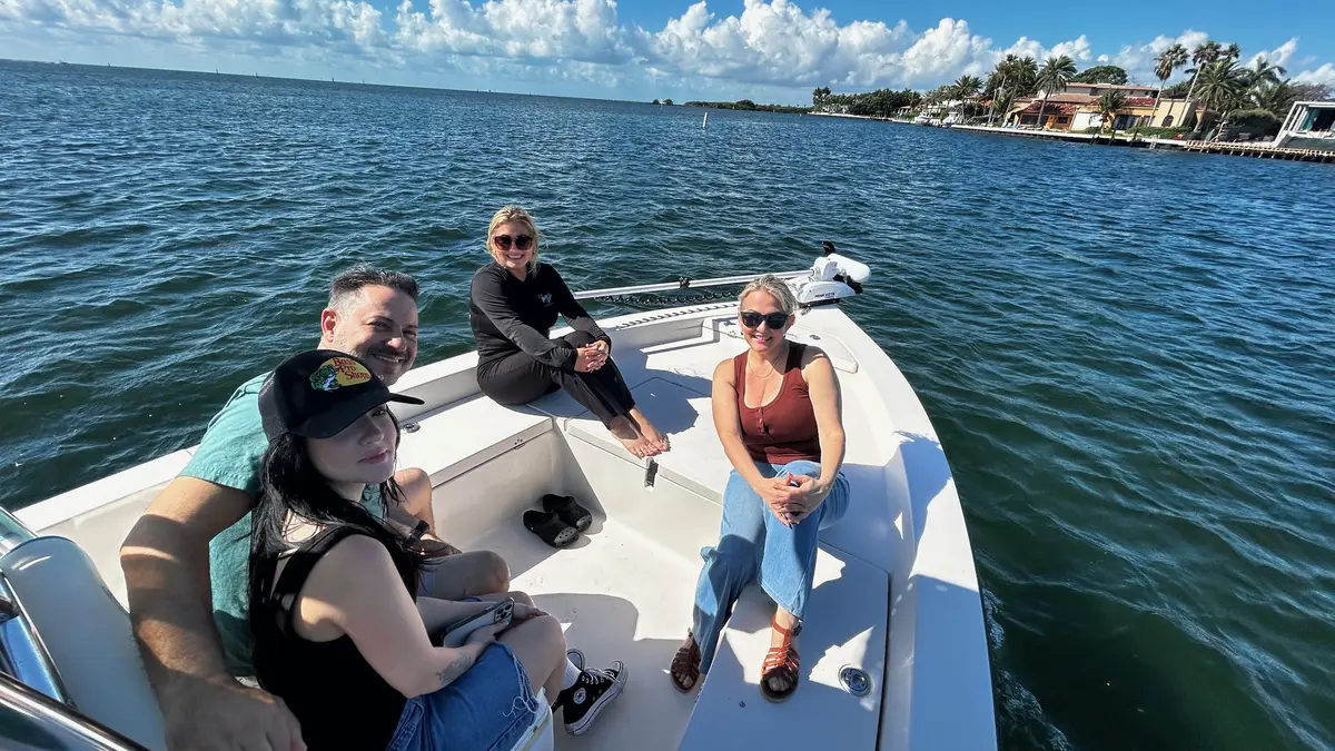 Happy group enjoying a family fishing charter on Biscayne Bay Miami